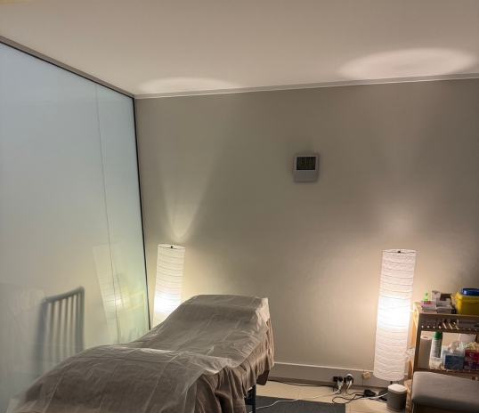 A massage table in a softly lit room, ideal for acupuncture for menopause sessions.